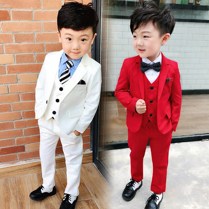 Boy in a four-piece formal wedding suit including a cotton blazer, vest, and pants, stylish and comfortable for special occasions.