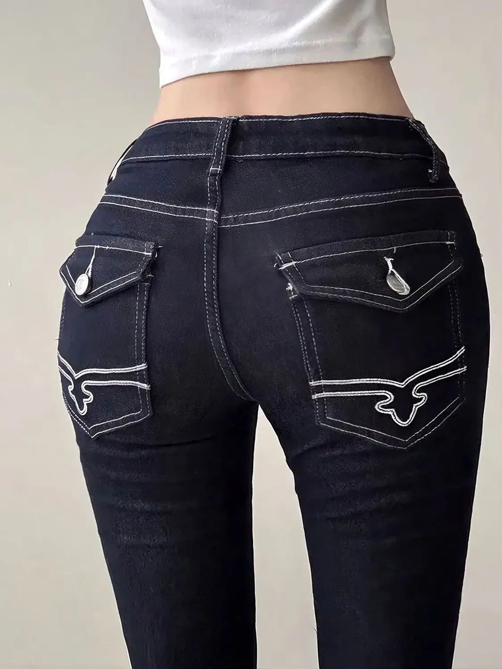 Women’s vintage blue embroidery flare jeans with high waist, bell bottom style, denim cargo design, Y2K streetwear fashion.