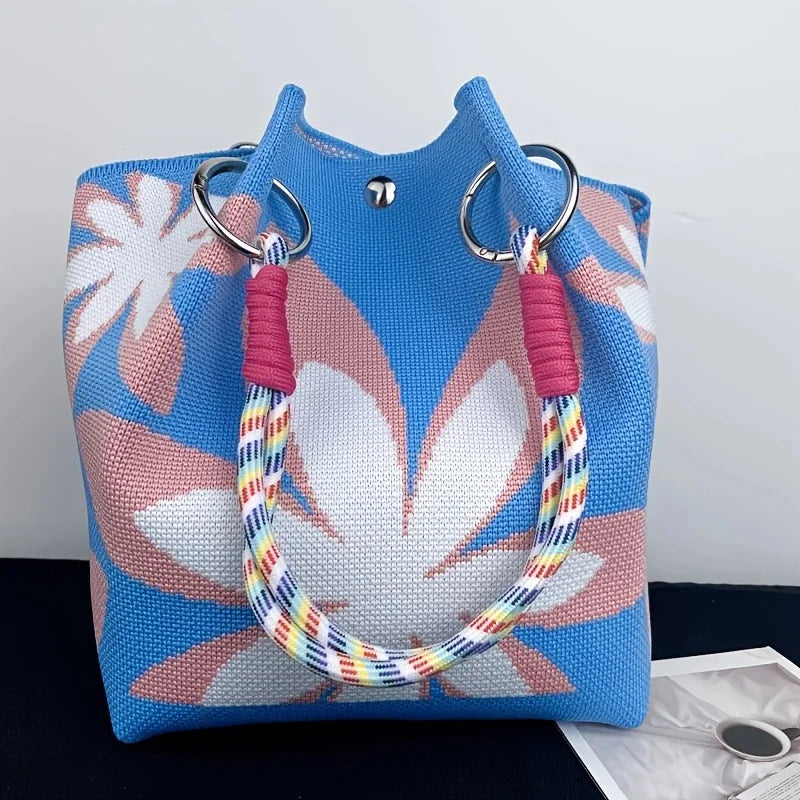 Women's vintage floral knit tote bag with adjustable straps and metal ring closures, ideal for casual travel and storage.
