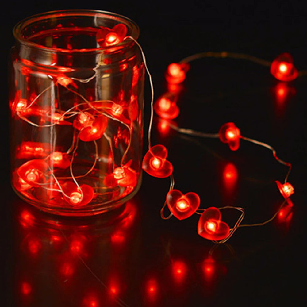 Red heart-shaped string lights with 20/30 LED bulbs, perfect for Valentine's Day, Christmas, or romantic home decor.