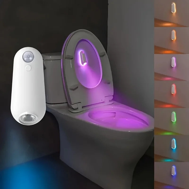 Showlu Smart General motion sensor mouse LED night light illuminating a dark room, with a sleek, compact design and soft white glow.