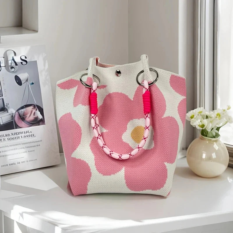 Women's vintage floral knit tote bag with adjustable straps, metal rings, snap closure, ideal for casual travel and storage.