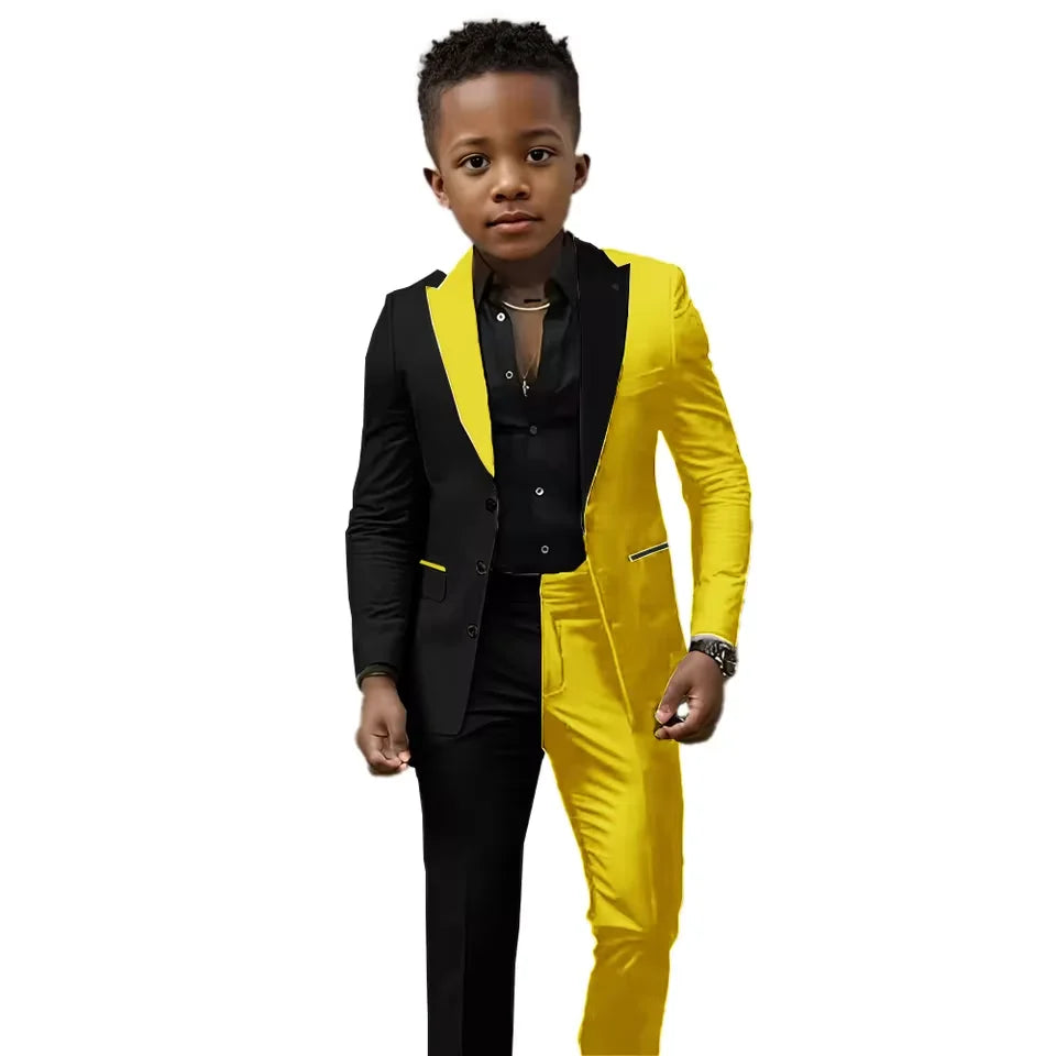 Boy's black and white spliced wedding suit with jacket and pants, slim fit tuxedo for ages 2T-16T, showing tailored details.