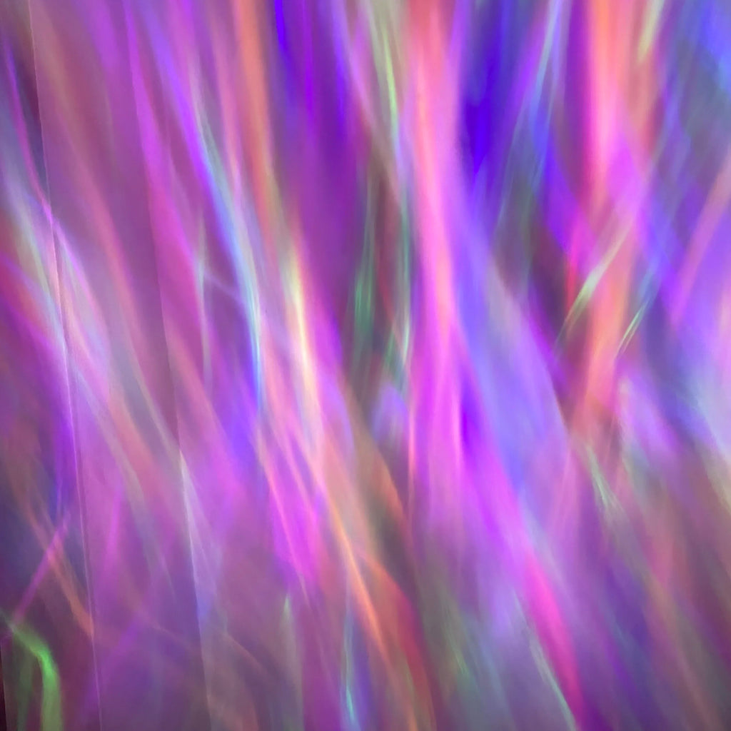 Showlu Smart General Aurora Borealis Projector displaying colorful northern lights on a wall in a dark room.