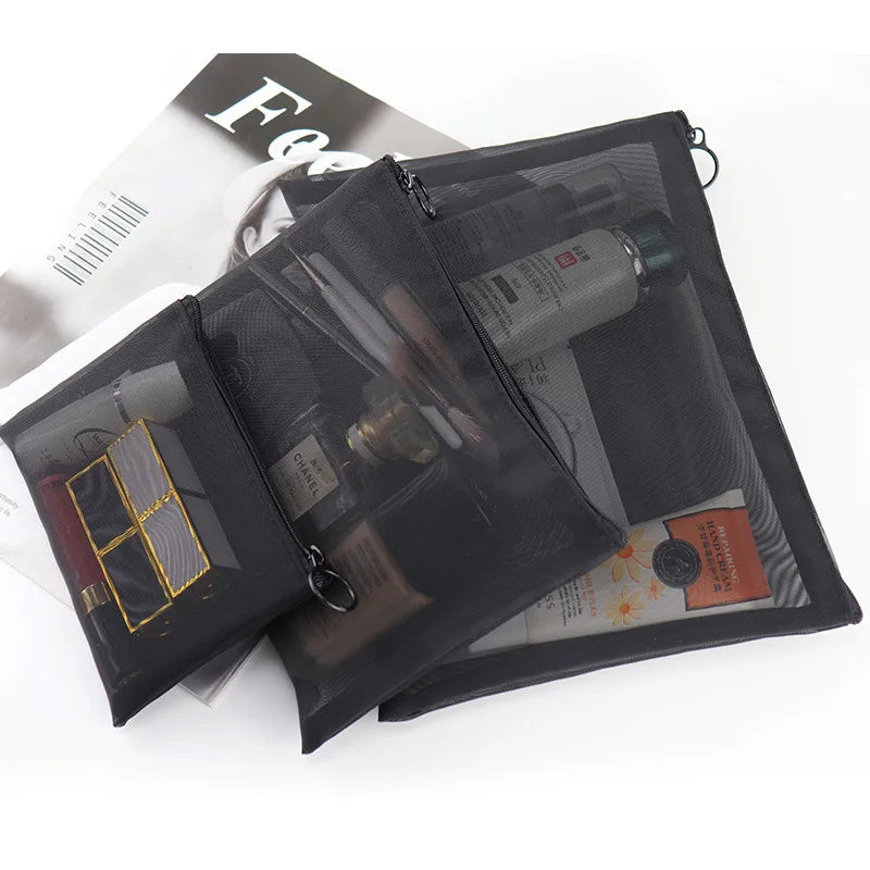 Large black portable travel makeup bag with transparent mesh compartments for outdoor storage and organization.