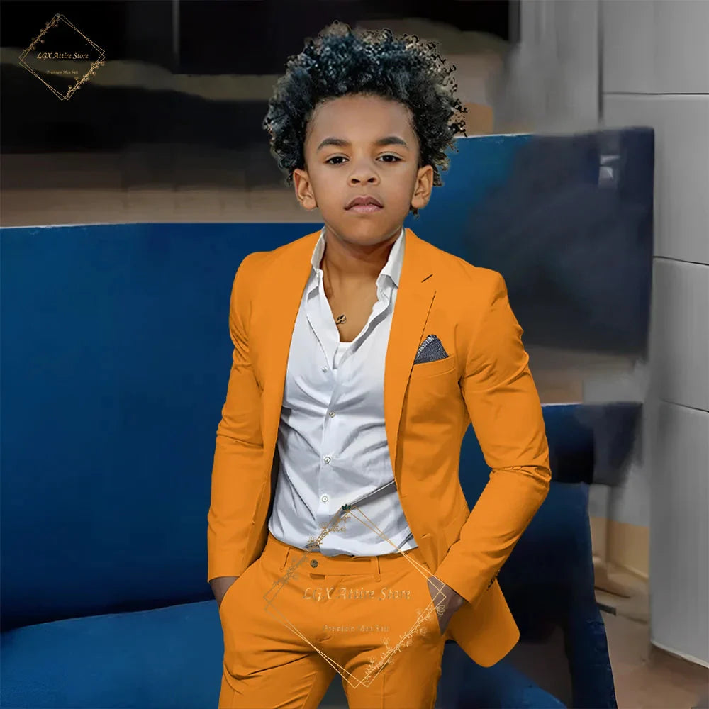 Boy wearing an orange slim fit two-piece suit with a single-breasted blazer and matching trousers, showcasing the SHOWLU FASHION SET.