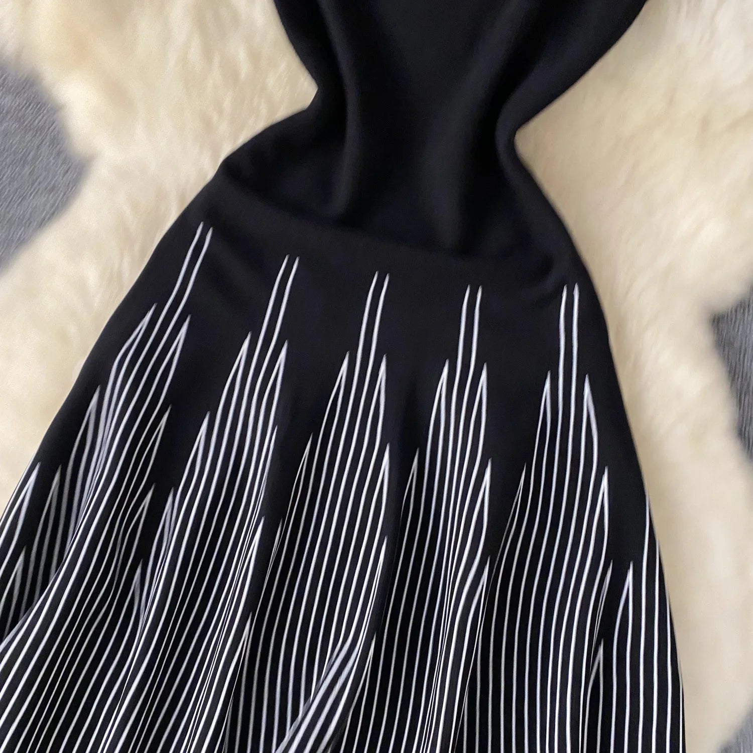 Elegant sleeveless mini dress for women featuring an A-line bodycon fit, round neck, and knitted fabric, perfect for parties and streetwear.