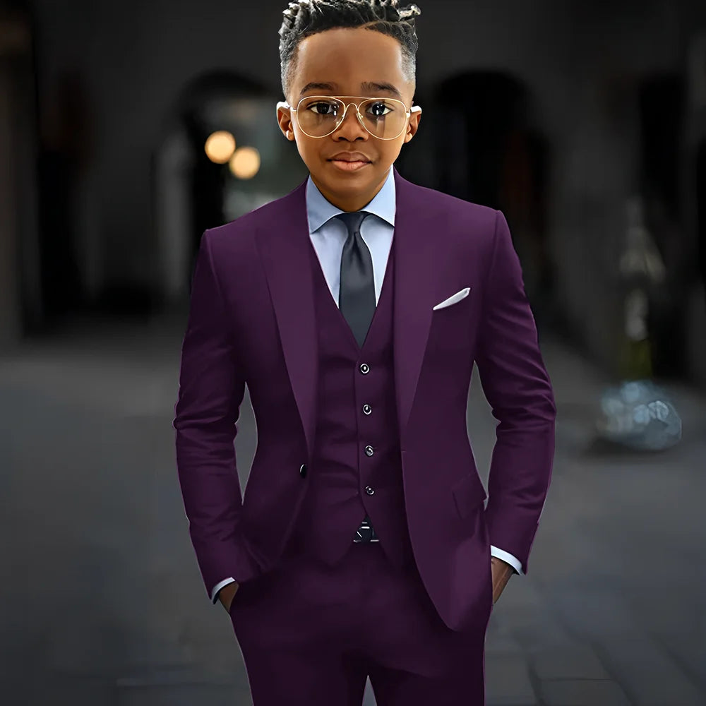Dark grey boys' suit set by Showlu Fashion, includes slim fit 3-piece jacket, pants, and vest with peak lapel details.