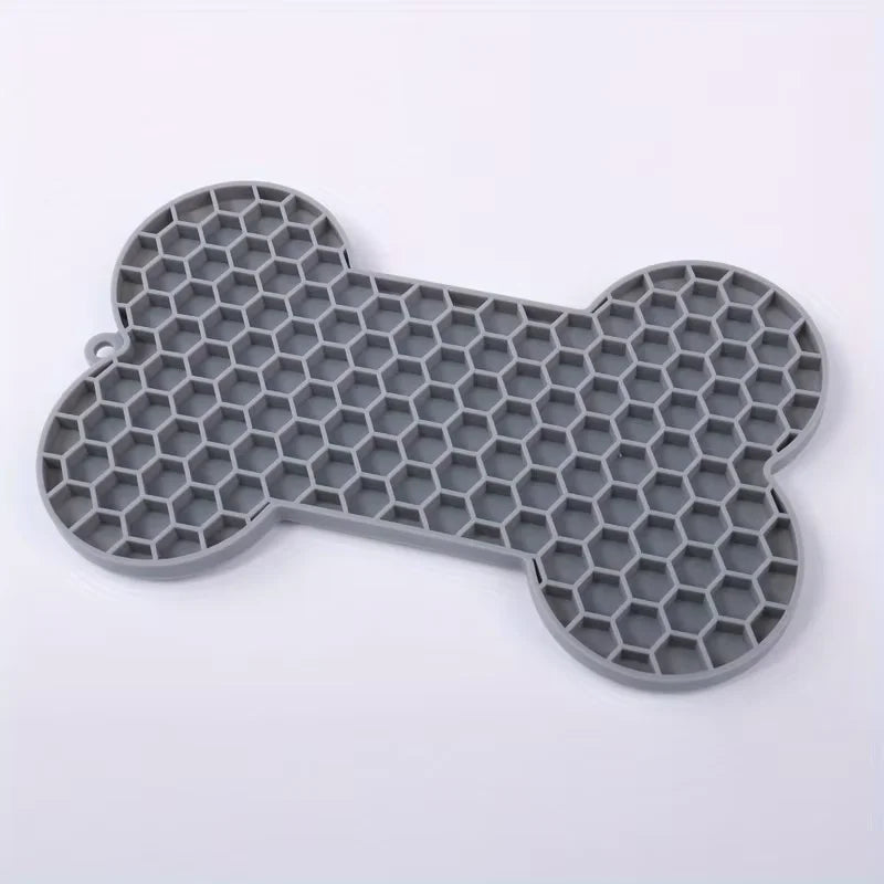 Silicone dog slow food pad with bone design, pet licking mat for dogs and cats, ideal for feeding and calming pets.