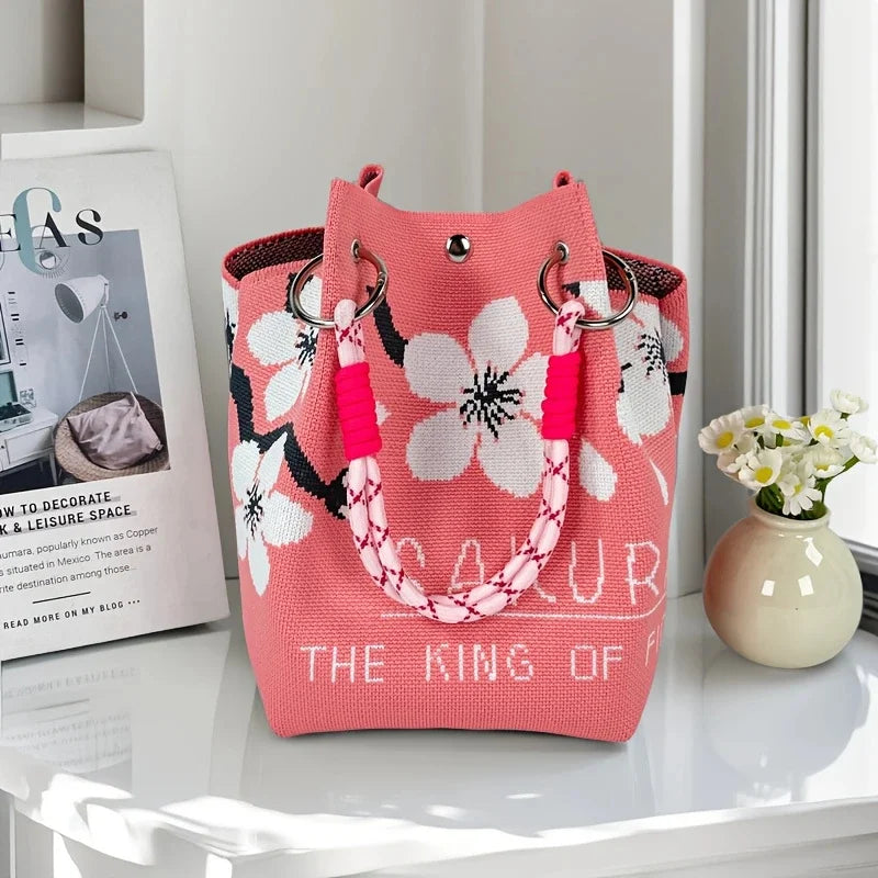 Women's vintage floral knit tote bag with adjustable straps, metal rings, snap closure, lightweight design, perfect for casual travel.