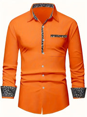 A bright orange long-sleeved men's button-down shirt with black and white floral trim.