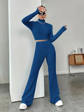 Autumn knitted two-piece women's bodycon suit with long sleeves, crop top, and flare pants in vintage Y2K style.