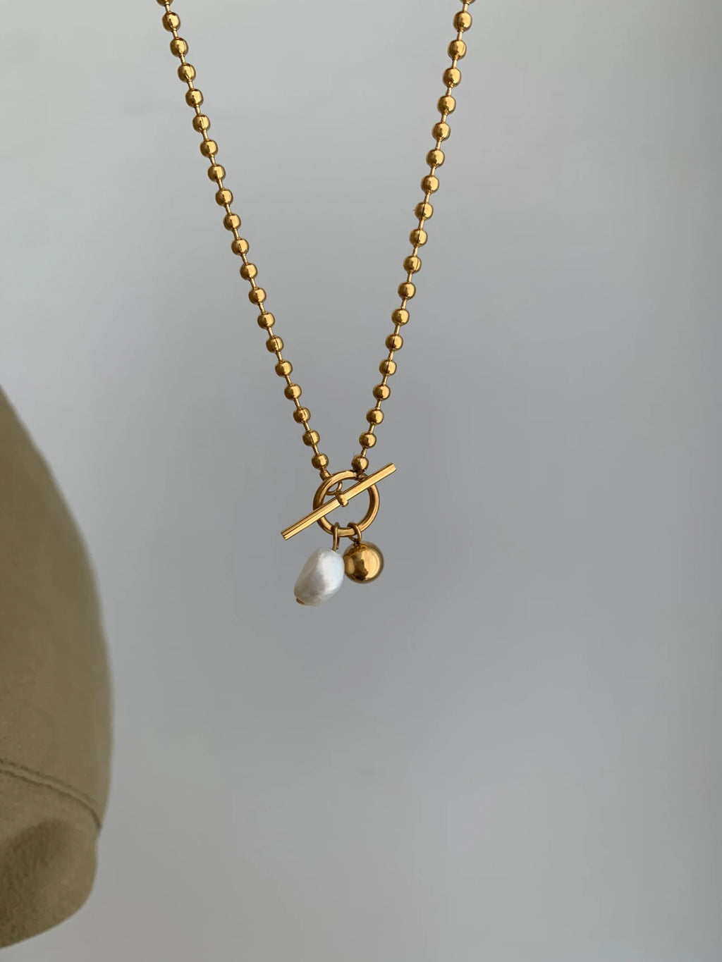 Showlu Fashion Store Peri'sBox minimalist stainless steel necklace with freshwater pearl pendant, baroque pearl, and OT buckle design.