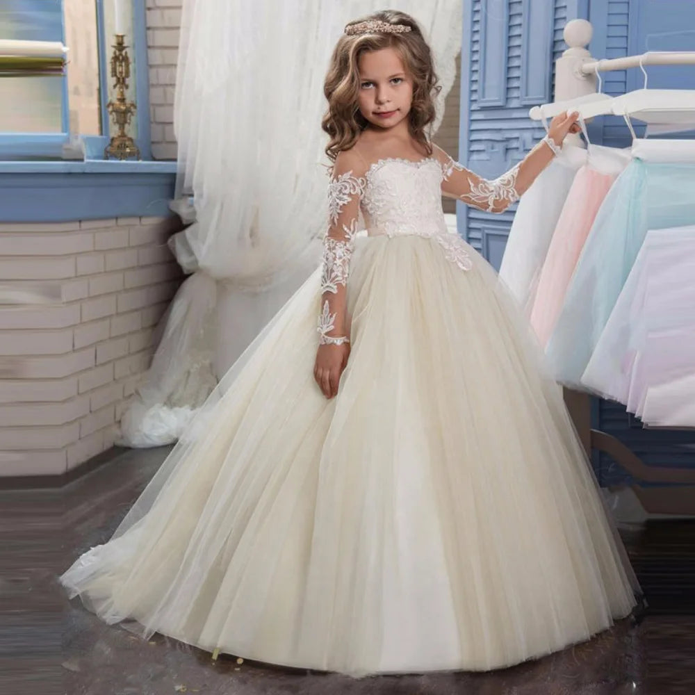 Light pink tulle flower girl dress with white appliques, long sleeves, designed for weddings, birthdays, and Holy Communion.