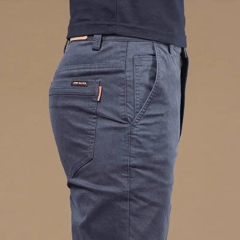 Showlu Men's slim straight cotton casual pants in light fabric, suitable for business or casual wear, displayed on a hanger.