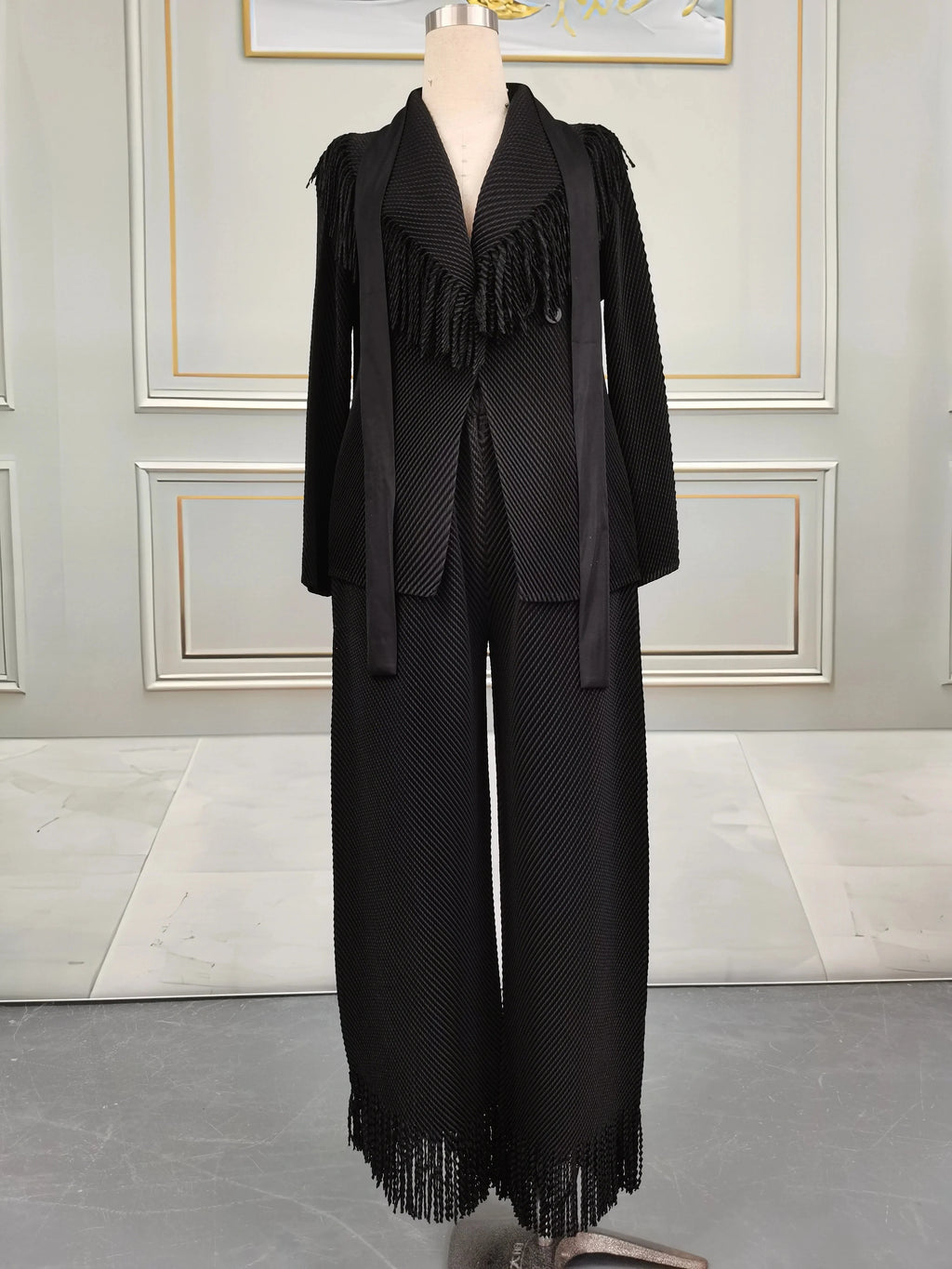 Miyake Folds women's fringe lapel coat and straight skirt two-piece set, shown in black fabric with stylish design and tailored fit.
