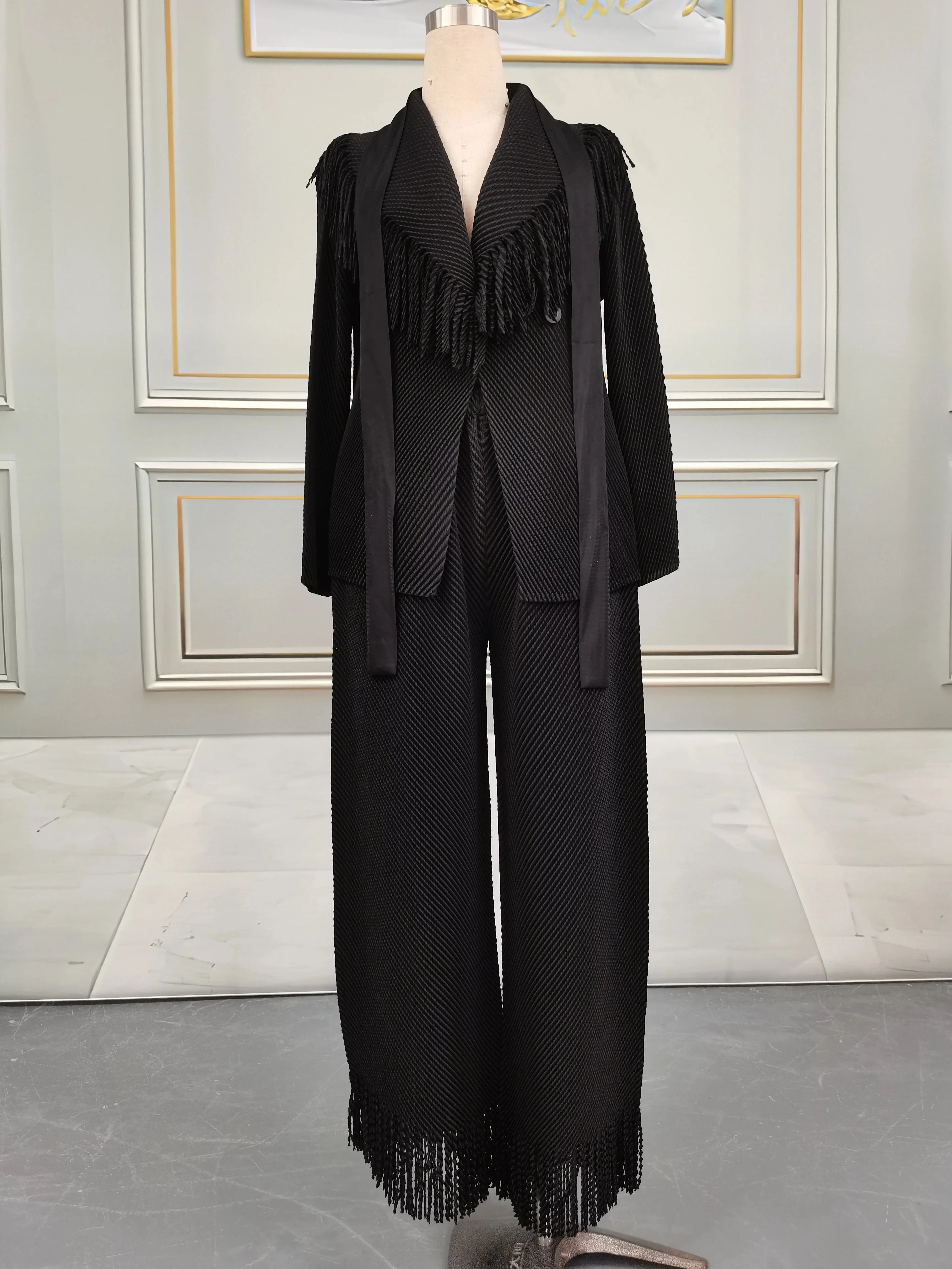 Miyake Folds women's fringe lapel coat and straight skirt two-piece set, shown in black fabric with stylish design and tailored fit.
