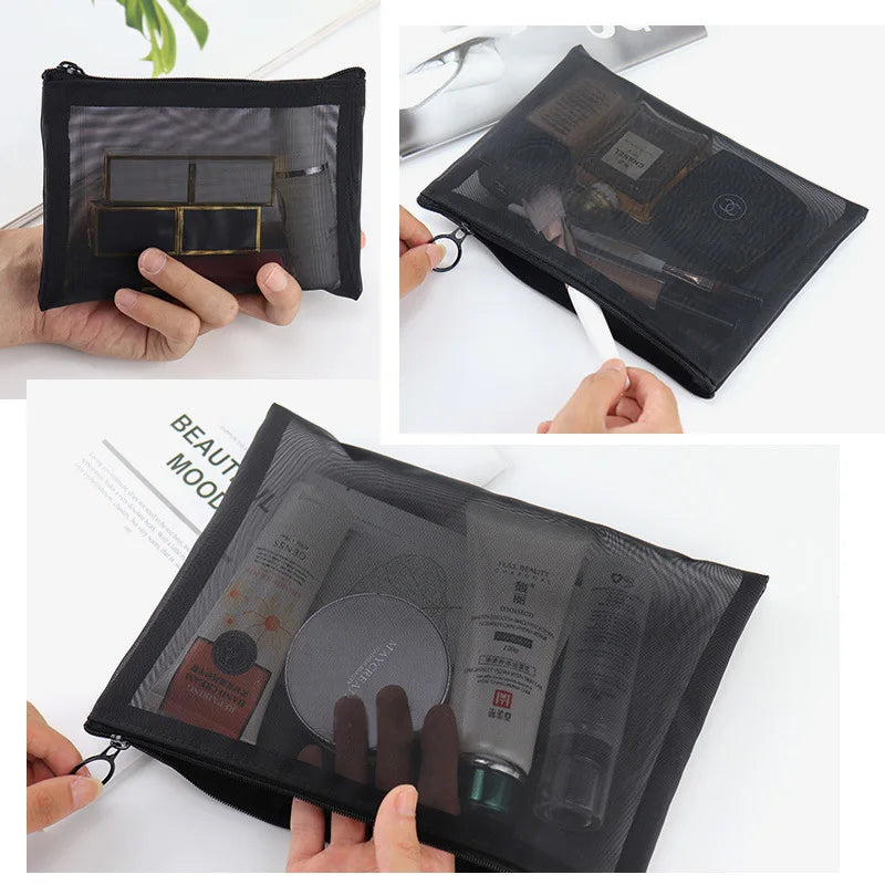 Large black portable travel makeup bag with transparent mesh sections for outdoor storage and organization.