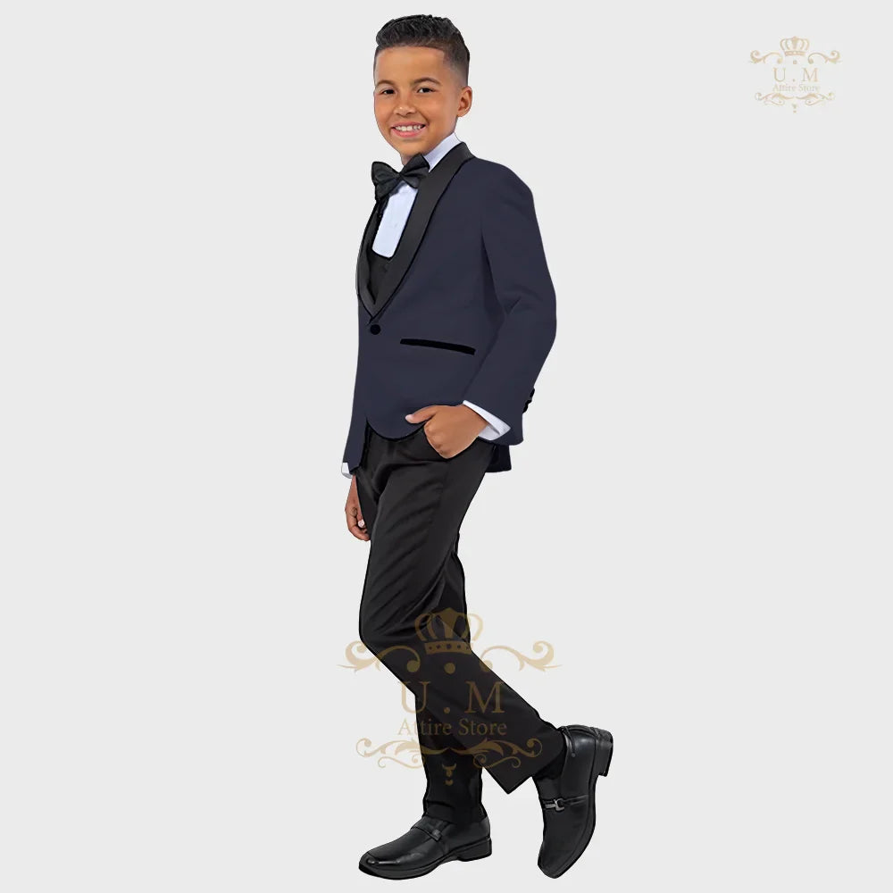 Boy wearing a white ZHIO boys' formal suit with tuxedo jacket, vest, and matching pants, perfect for special occasions.