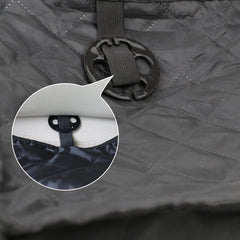 A black quilted car pet mat featuring a circular anchor for securing it to a vehicle seat.