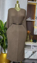 Miyake pleated V-neck dress with bat sleeves, lace-up detail, slim waist, in a spring 2025 style for women, shown in black fabric.