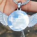 Custom angel wing round photo necklace with personalized pendant and tennis chain, featuring a custom picture and elegant jewelry design.