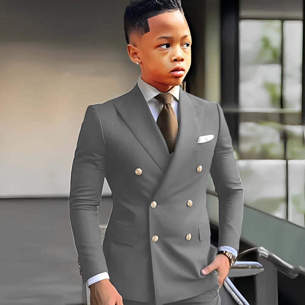 Elegant navy blue boys' tuxedo with peak lapel, double-breasted suit for formal occasions, wedding, or business events.