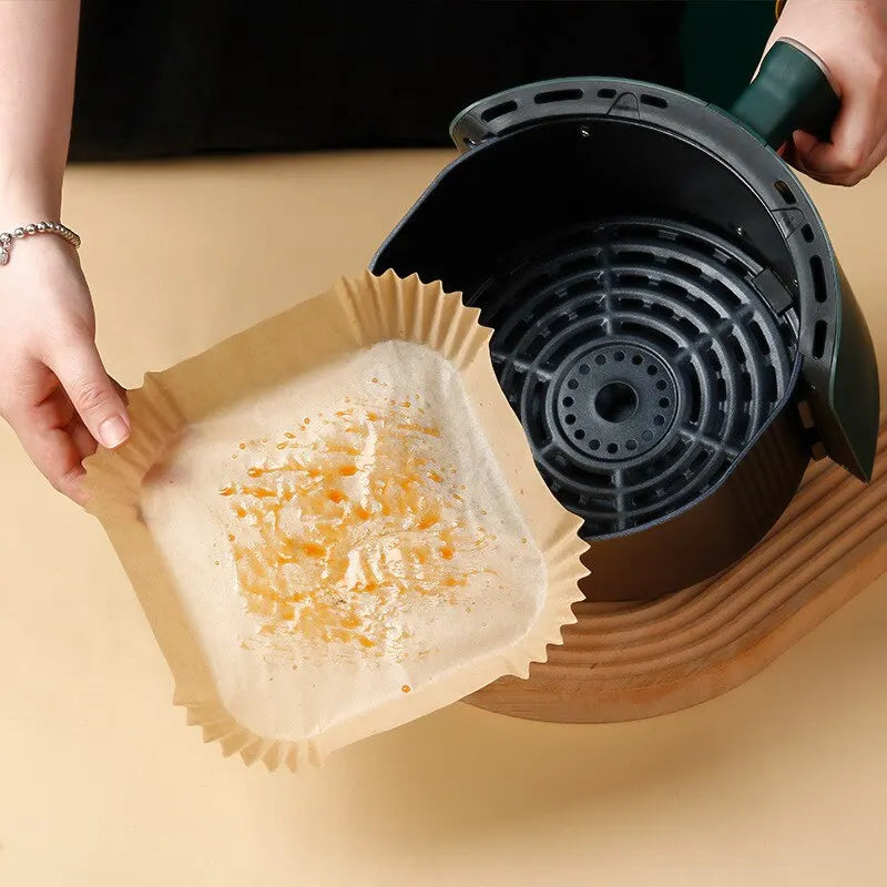 Set of 50 disposable parchment paper sheets for air fryer and baking, with wood pulp steamer and cheesecake accessories.