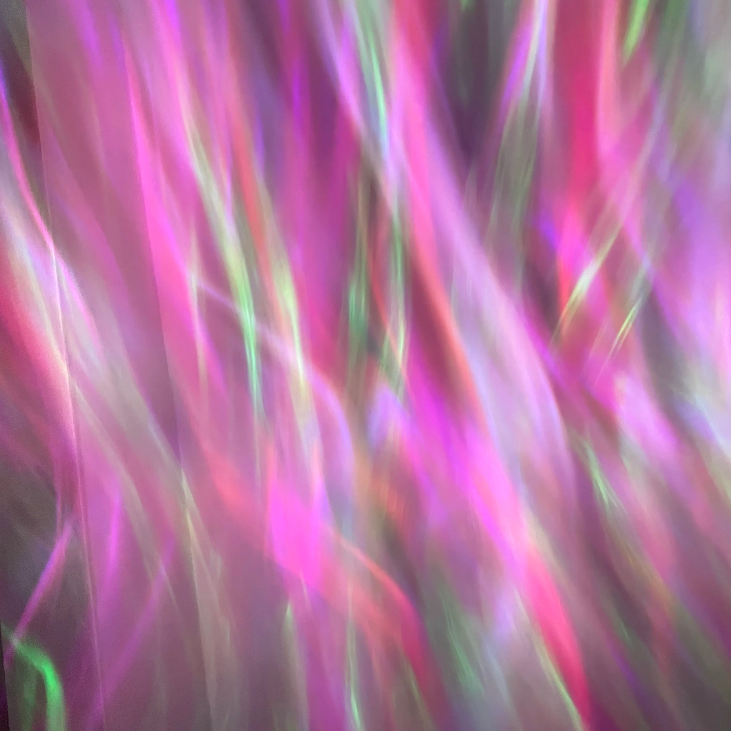 Showlu Smart General Aurora Borealis Projector displaying vibrant green and purple northern lights on a dark room wall.