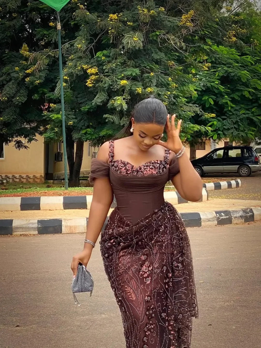 Elegant brown lace evening dress by Showlu Fashion, featuring beads and traditional African wedding and birthday gown style.