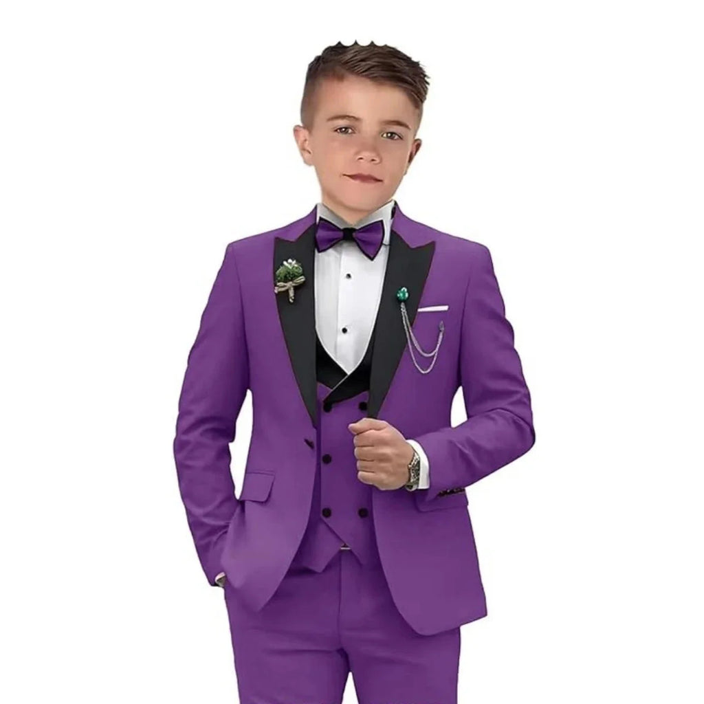 Boy wearing a champagne velvet tuxedo suit set with blazer, dress pants, and vest from SHOWLU FASHION STORE.