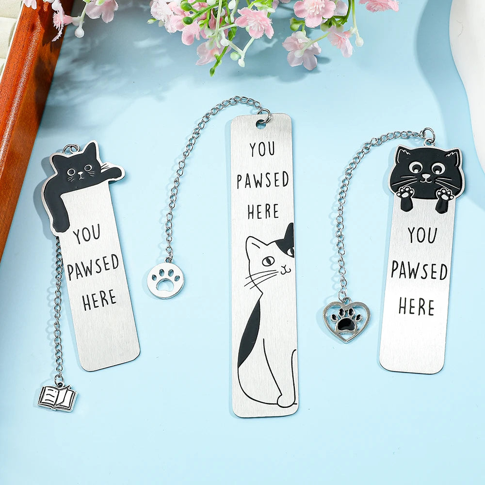 Colorful stainless steel waving cat bookmark with geometric design, ideal for marking pages in books.