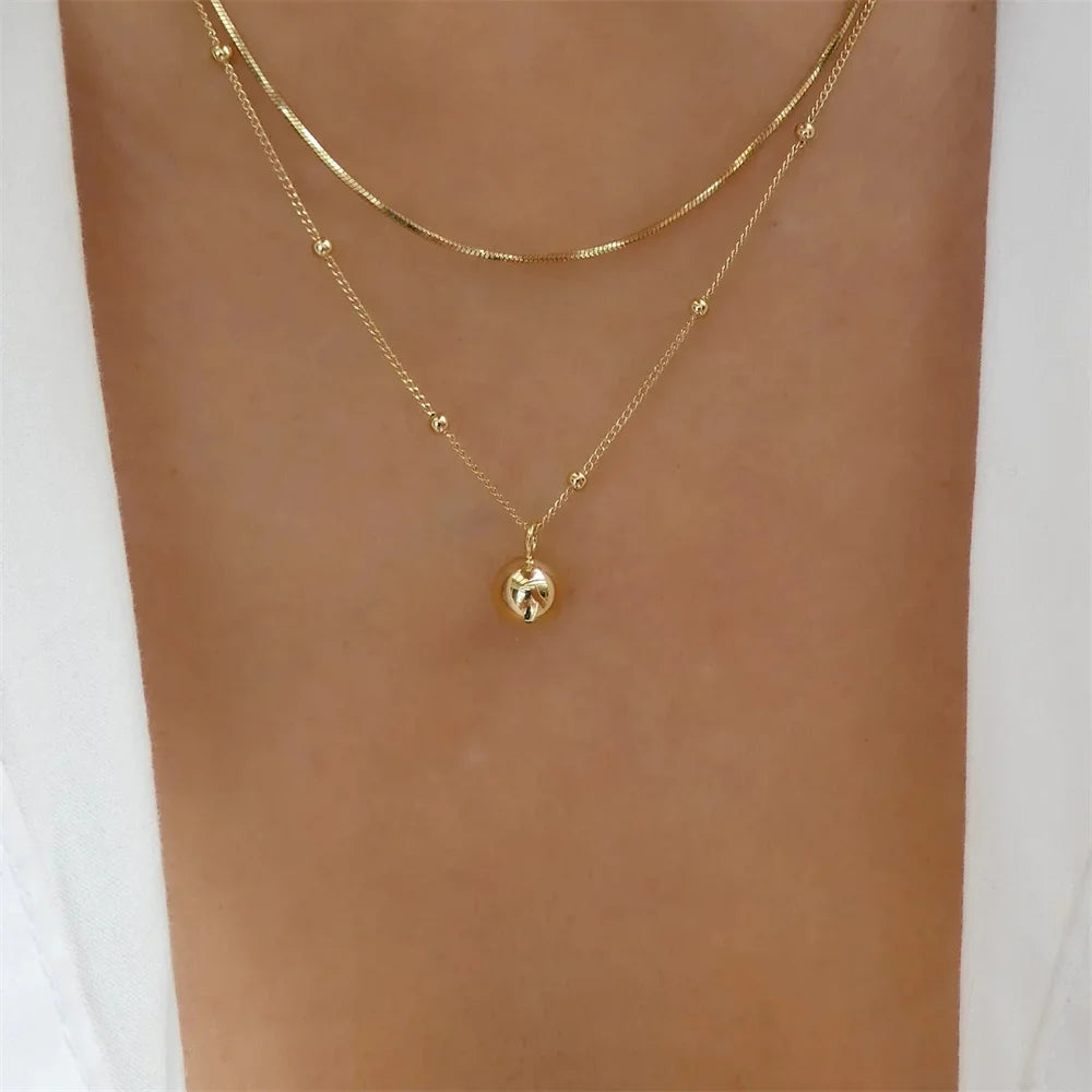 Elegant vintage round pearl pendant necklace for women with multi-layer gold chain, trendy jewelry choker style.