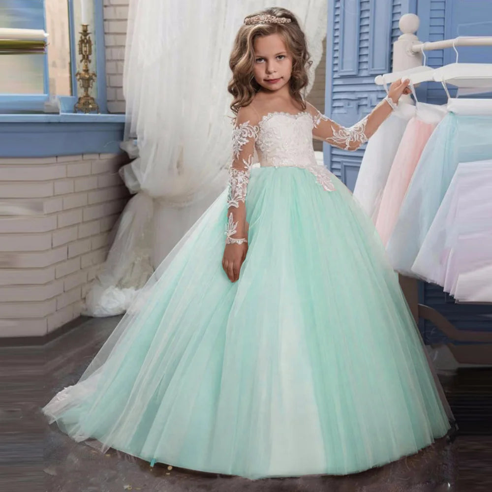 Light pink flower girl dress by Showlu Fashion with tulle, white appliques, long sleeves, suitable for weddings or birthday parties.