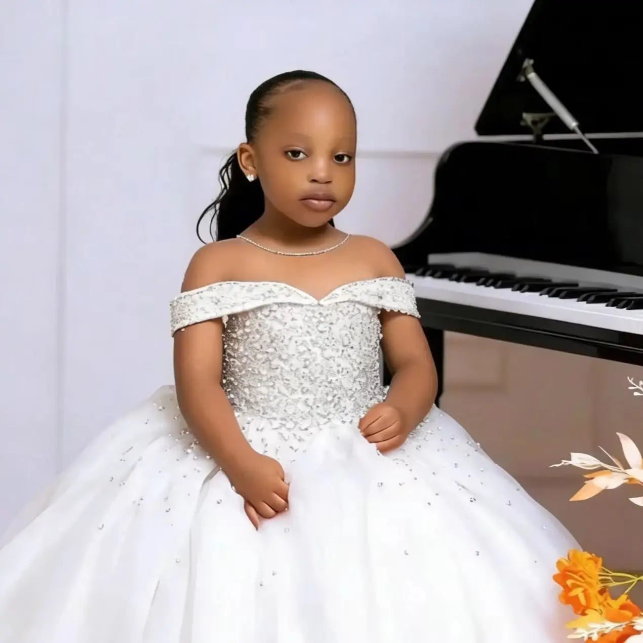 Elegant off-shoulder tulle flower girl communion dress with floral details, designed by Showlu Smart General.