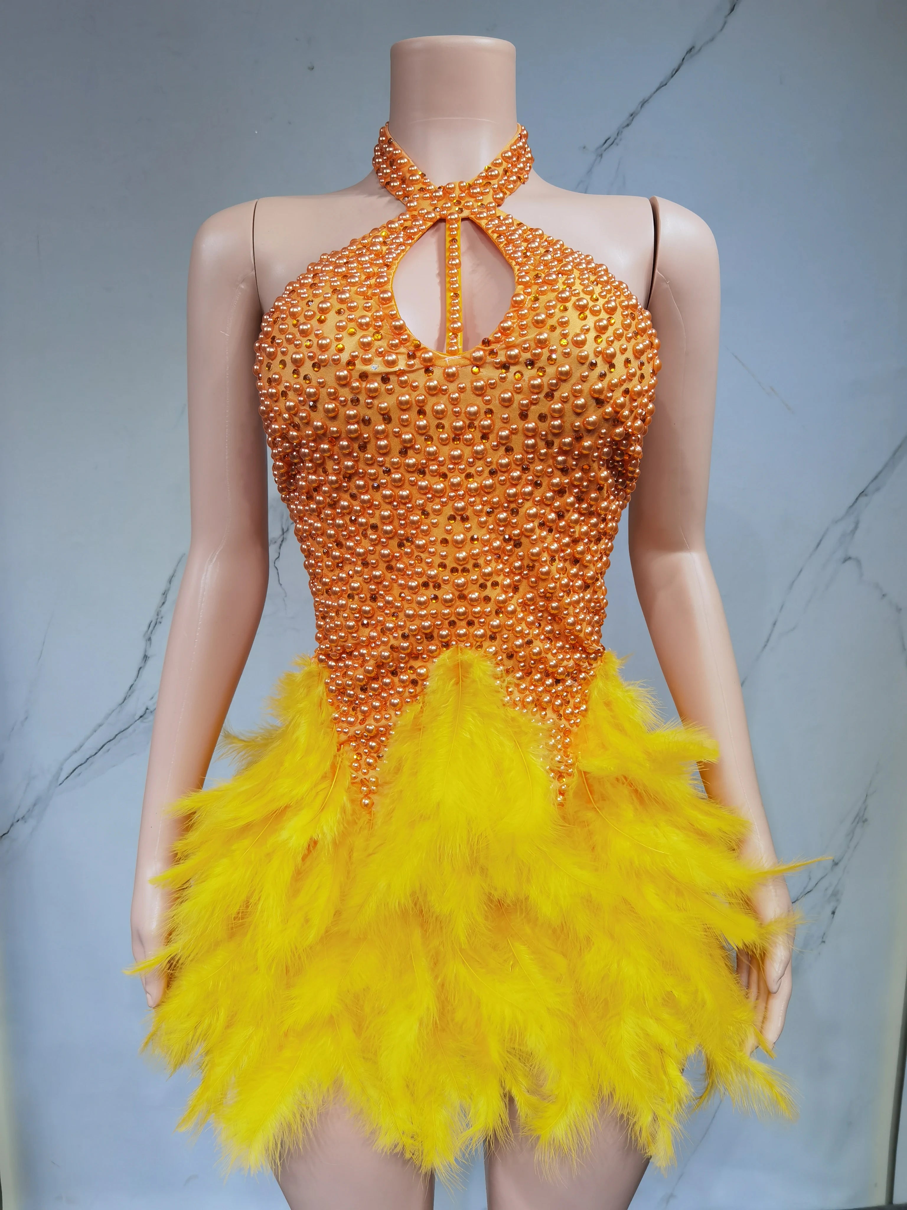 Sexy Latin dance dress by Showlu Fashion Store with airy hollow design, feather skirt, and hanging neck style for performance or events.