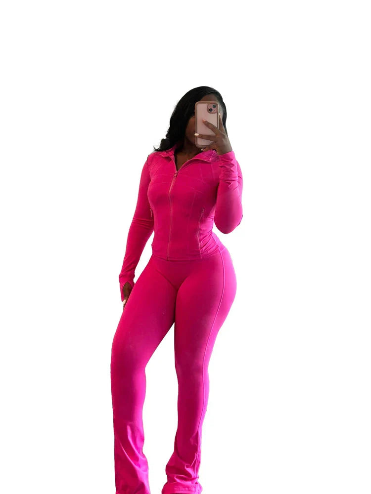 Women's two-piece tracksuit by SHOWLU FASHION with flared pants and zip-up top, shown in a stylish black fabric.