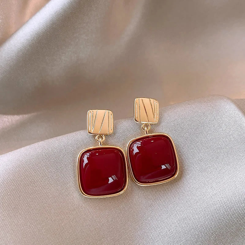Showlu Fashion zircon cross stud earrings with geometric copper design, showcasing elegant jewelry style.