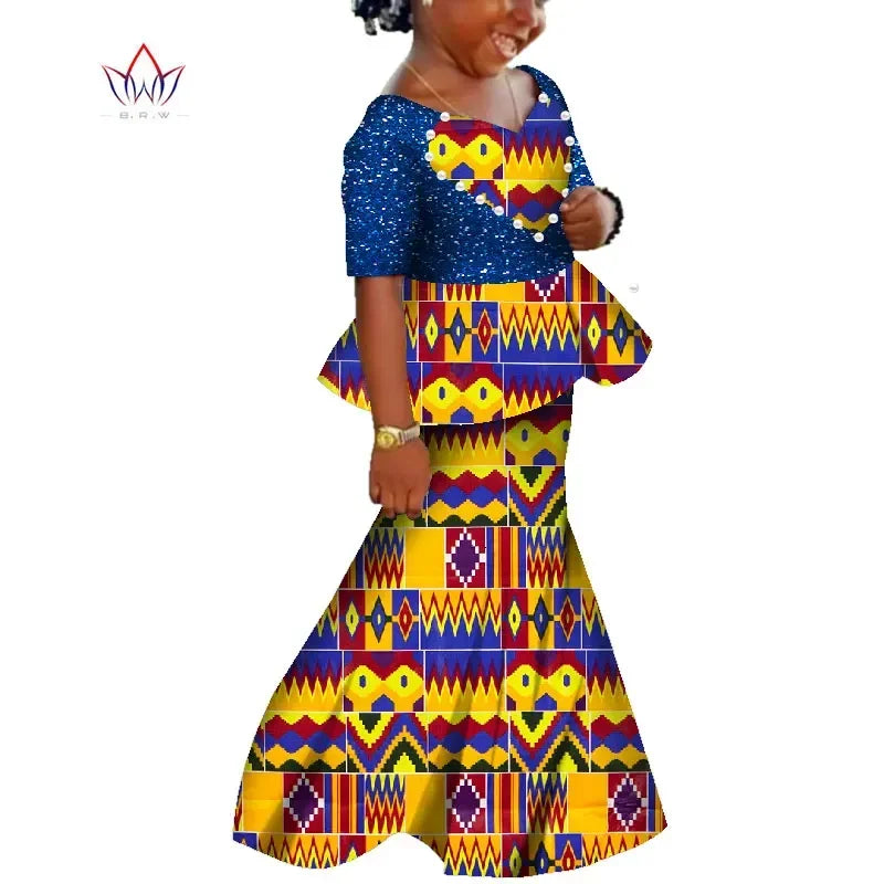 Girl wearing a colorful BintaRealWax African Dashiki print cotton dress by SHOWLU FASHION STORE, perfect for summer clothing.