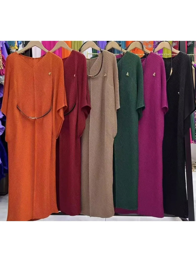 Miyake pleated V-neck lace-up dress with bat sleeves, slim waist, and spring style, featuring a foreign-inspired design.
