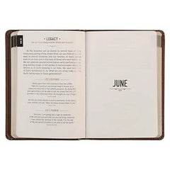 An open brown leather devotional journal showing a page for May 31 and a June divider page.
