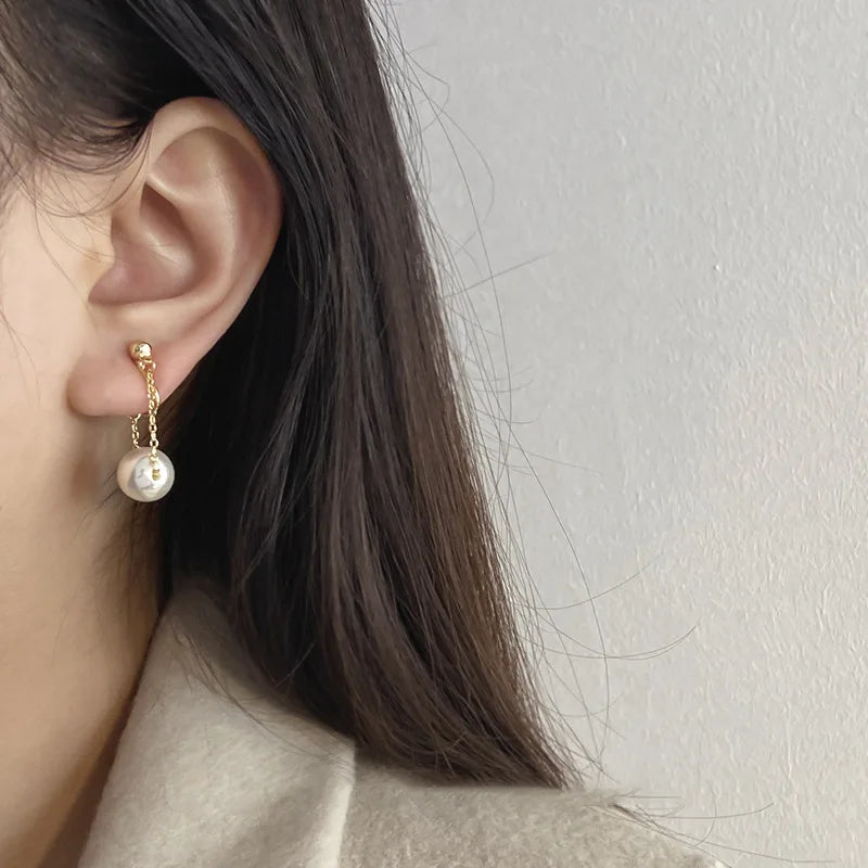 Vintage simple pearl mosquito coil clip earrings for women, featuring hanging chain drop design, painless non-piercing jewelry.