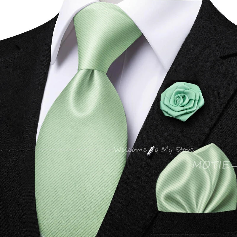 Men's solid green tie set with pocket square, flower brooch, cufflinks, and collar accessory for wedding or daily wear.