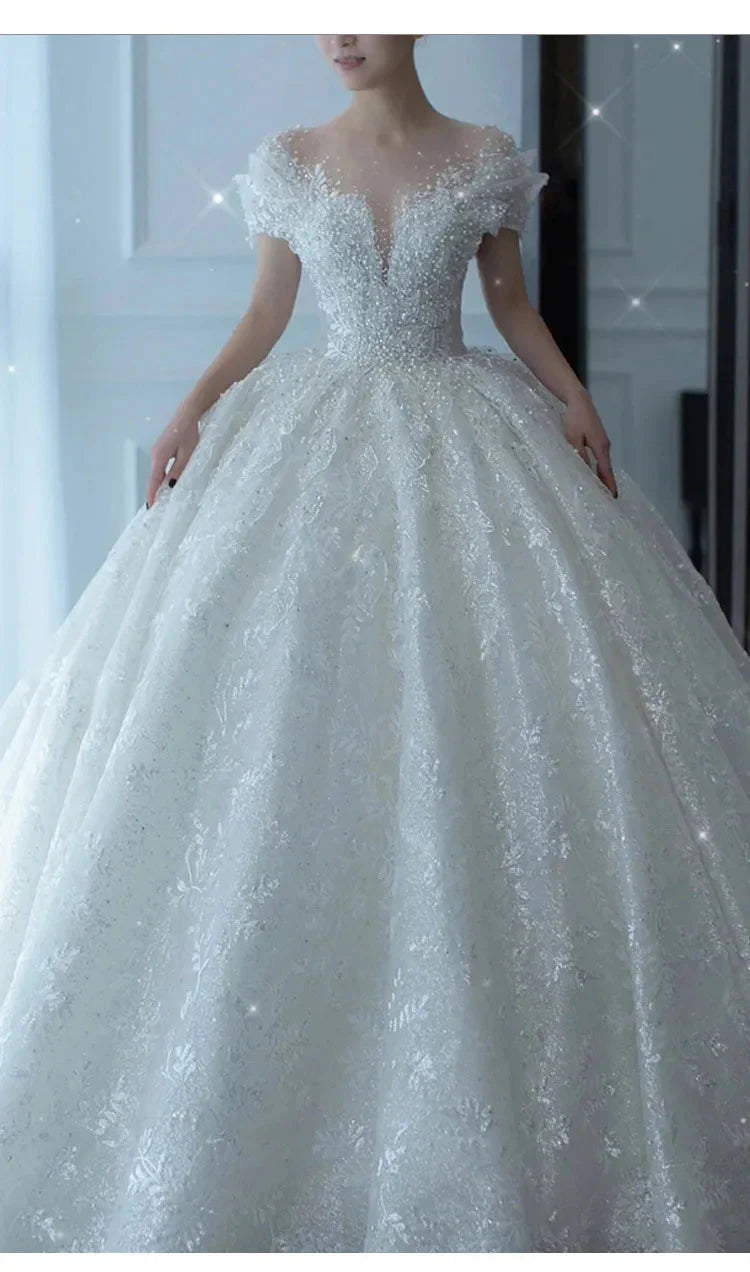 Elegant SHOWLU FASHION crystal beaded tulle ball gown wedding dress with intricate embellishments and flowing skirt.