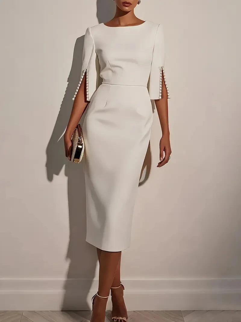 Beaded slim fit midi dress from Showlu Fashion with elegant round neck and sheath design, showing a close-up of the dress fabric and bead details.