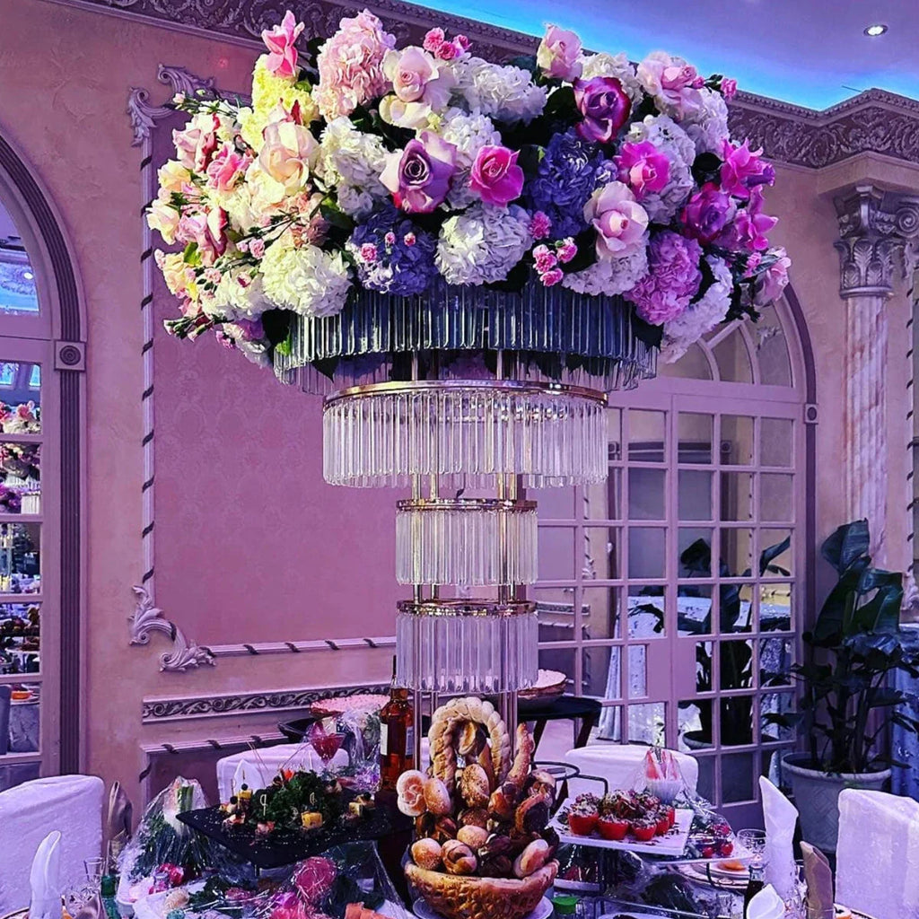 Tall gold crystal wedding centerpiece on a 4-layer metal stand, featuring elegant crystal accents and intricate metal design.
