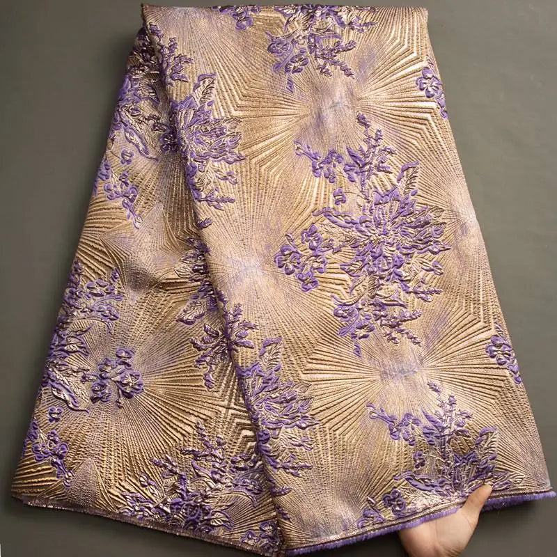 Nigerian Damask tulle fabric with floral brocade jacquard lace in intricate gold and silver patterns, ideal for elegant clothing designs
