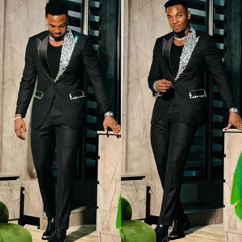Slim fit black men's suit with single-breasted blazer and matching pants, featuring peak lapel and high-quality fabric.