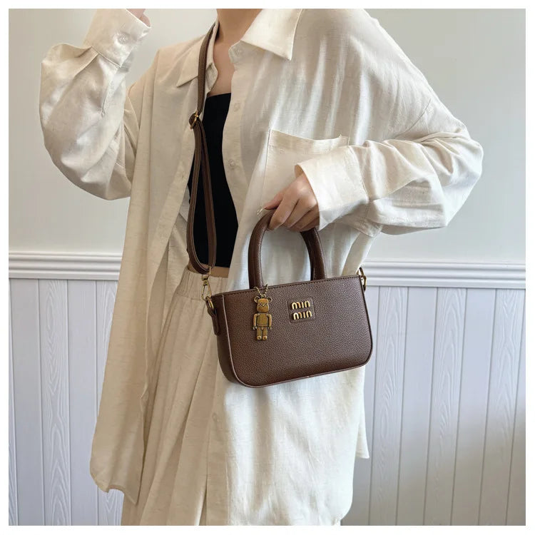 Minimalist luxury phone pouch by 1170uf-he featuring a shoulder crossbody design in sleek modern style.
