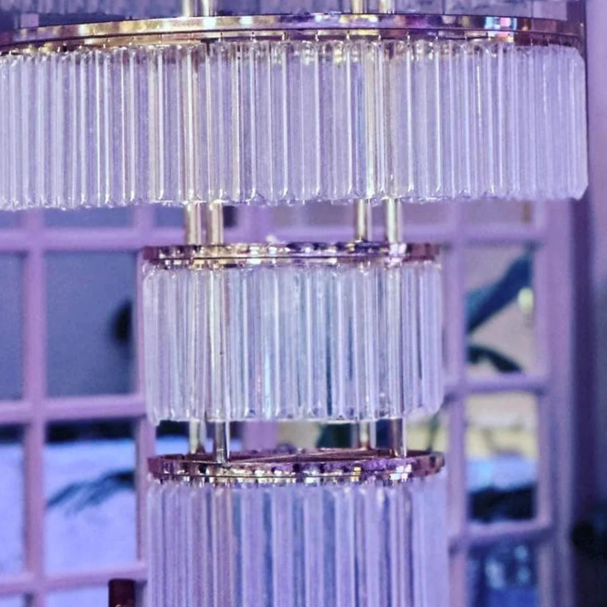 Tall gold crystal wedding centerpiece with a four-layer metal stand, perfect for elegant event decor.